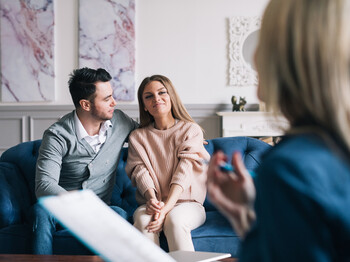 Psychological consultation. Beautiful and happy young couple visiting psychologist for relationship counseling.
